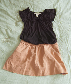 black short sleeve blouse and a pink cotton skirt
